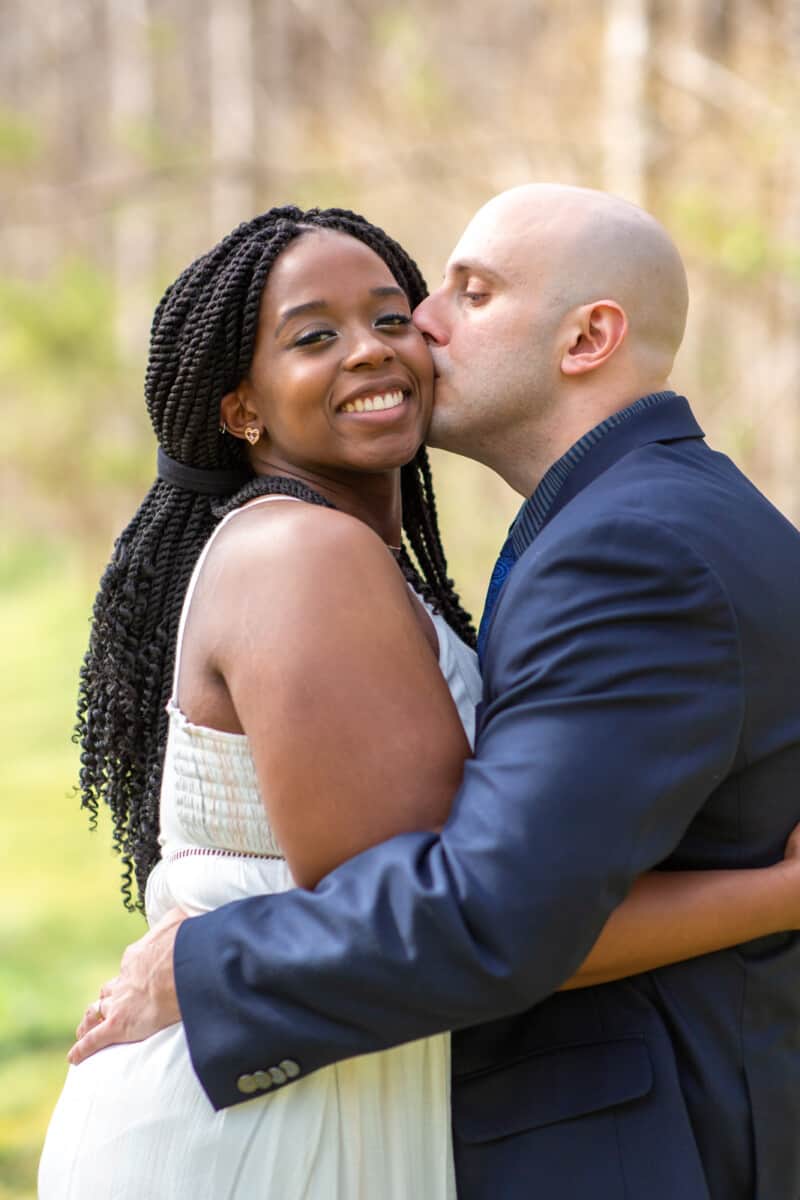 Spring Nashville Elopement at Butterfly Hollow; bride smiling as he kisses her cheek
